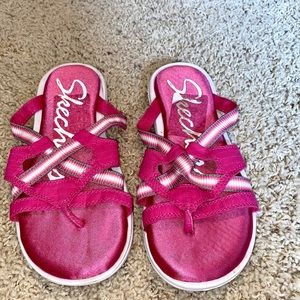 Pink sketcher sandals.
